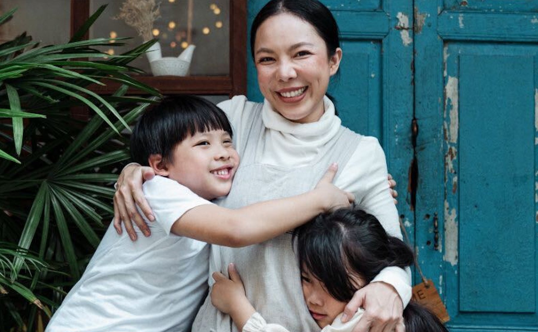 Two children hugging their mom