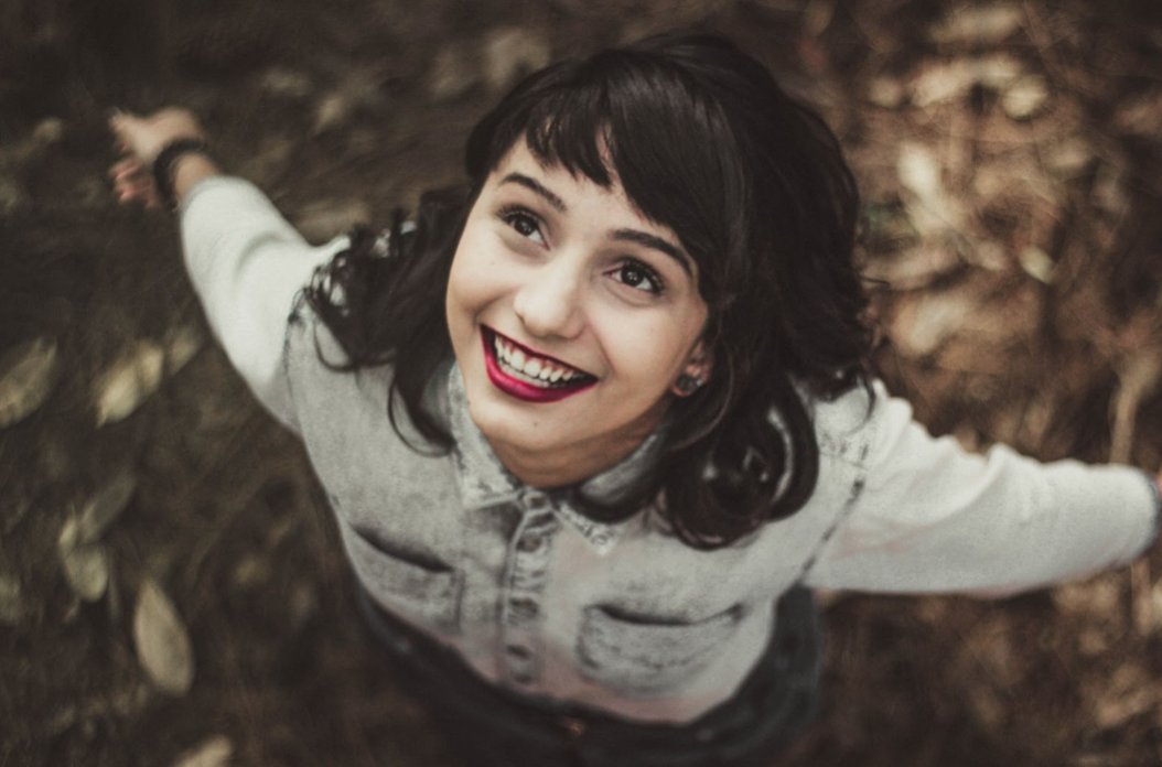Happy young woman (Photo by Allef Vinicius on Unsplash)
